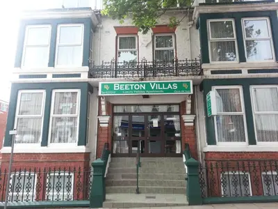 a building with a sign that reads be reborn villas at Beeton Villas Holiday Apartments in Blackpool
