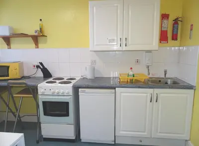 a kitchen with a white stove and a sink at Beeton Villas Holiday Apartments in Blackpool