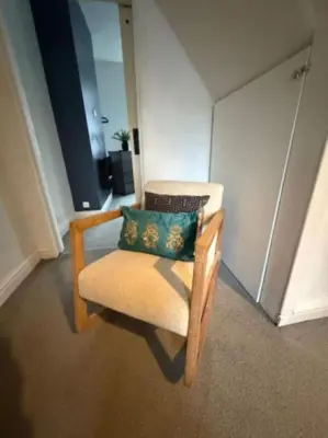 a chair with a pillow sitting in a room at The Wordsworth in Barrow in Furness