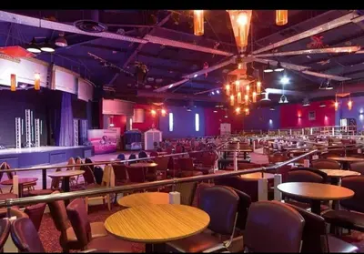 a large room with tables and chairs in it at Dennys Holiday Home Pet Free in Blackpool