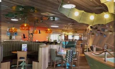a restaurant with a bar with a table and chairs at Dennys Holiday Home Pet Free in Blackpool