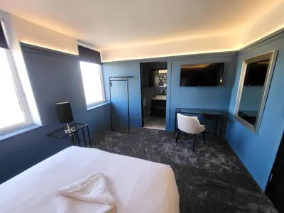 a bedroom with a white bed and blue walls at 272 Accommodation in Blackpool
