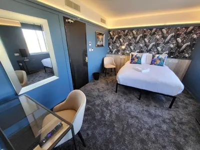 a hotel room with a bed and a chair at 272 Accommodation in Blackpool