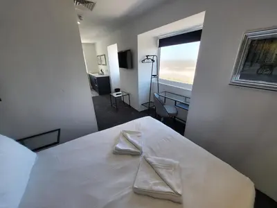 a bedroom with a white bed with two napkins on it at 272 Accommodation in Blackpool