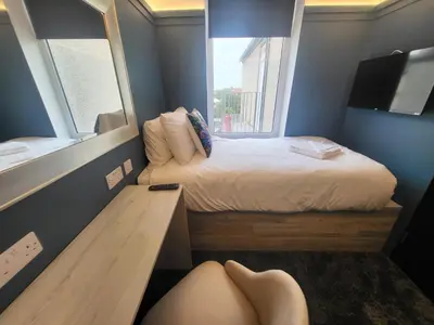 a person laying on the floor in a small bedroom at 272 Accommodation in Blackpool