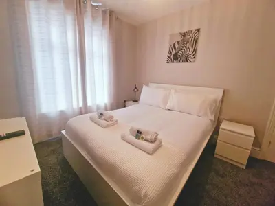 a bedroom with a bed with two towels on it at Upscale Luxury Home by Liverpool Football Stadium in Liverpool
