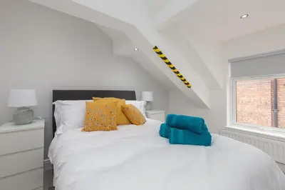 a bedroom with a white bed and a window at Lytham St Annes Luxury Apartment - No 3 Tides Reach in Lytham St Annes
