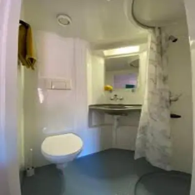 a bathroom with a white toilet and a sink at Elegant 4-Bedroom Apartment at Kexgill in Preston