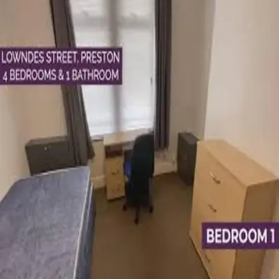a room with a bed and a sign on the wall at Elegant 4-Bedroom Apartment at Kexgill in Preston