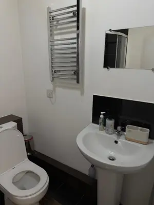 a bathroom with a white toilet and a sink at Central Wigan Stay in Wigan