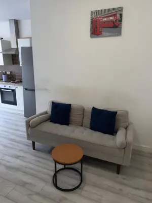 a living room with a couch and a table at Central Wigan Stay in Wigan