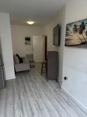 a living room with a couch and a television at Central Wigan Stay in Wigan