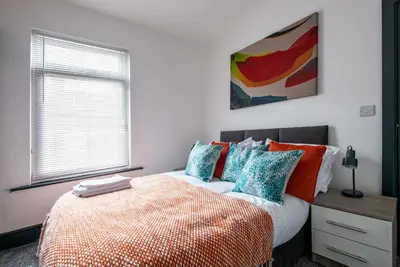 a bedroom with a bed and a window at Prime Location! 3-Bedroom House Near Anfield & Goodison Park in Liverpool