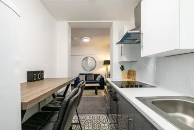 a kitchen and living room with a table and chairs at Prime Location! 3-Bedroom House Near Anfield & Goodison Park in Liverpool