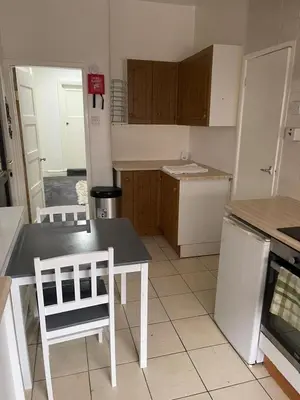 a small kitchen with a table and chairs in it at The Beechwood in Blackpool