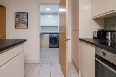 a kitchen with a washer and dryer in a room at Liverpool Gem, Spacious 2BR Apt, Sleeps 8 in Liverpool