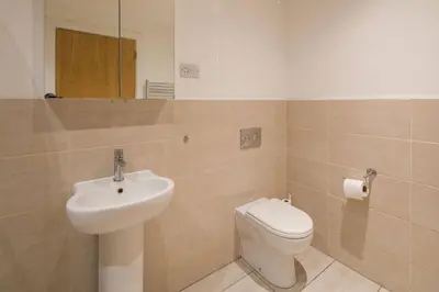 a bathroom with a toilet and a sink at Liverpool Gem, Spacious 2BR Apt, Sleeps 8 in Liverpool