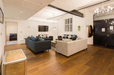 a living room with two couches and a tv at Liverpool Gem, Spacious 2BR Apt, Sleeps 8 in Liverpool