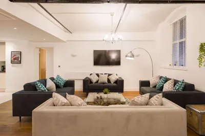 a living room with two couches and a tv at Liverpool Gem, Spacious 2BR Apt, Sleeps 8 in Liverpool