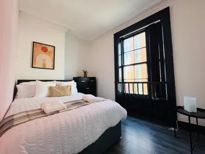 a bedroom with a large bed and a window at Pembroke Place Private room 5 in Liverpool