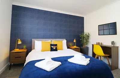 a bedroom with a large bed with towels on it at Lancaster 2 Bedroom House - Driveway Parking in Lancaster