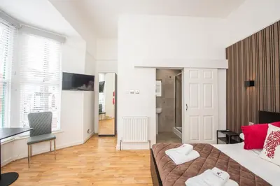 a bedroom with a bed and a desk and a room with at The Moscow Studios in Liverpool