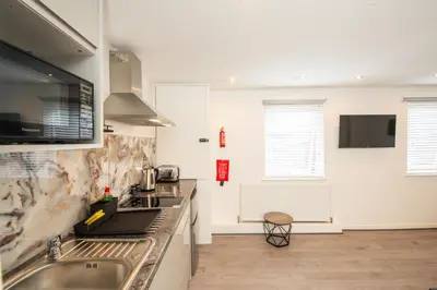 a kitchen with a sink and a counter top at The Moscow Studios in Liverpool