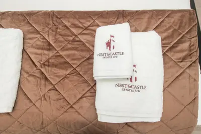 two white towels sitting on top of a brown blanket at The Moscow Studios in Liverpool