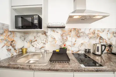 a kitchen with a sink and a microwave at The Moscow Studios in Liverpool