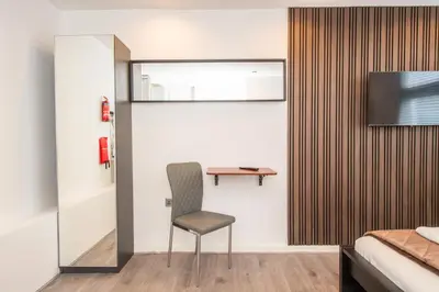 a bedroom with a desk and a chair in a room at The Moscow Studios in Liverpool