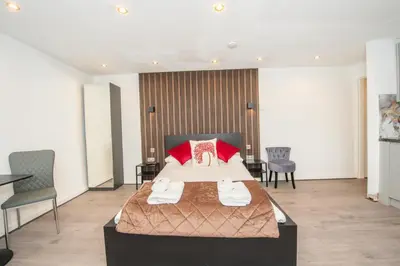 a hotel room with a bed and a table and chairs at The Moscow Studios in Liverpool