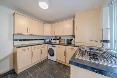 a kitchen with a sink and a dishwasher at Sleeps 7- Spacious 3 Bed House w Free Parking in Liverpool