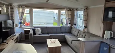 a living room with a couch and a table at Ocean Edge 13 in Heysham