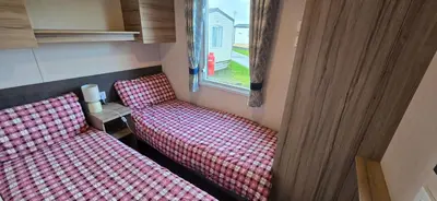 a room with two chairs and a window at Ocean Edge 13 in Heysham