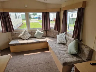 a living room with a couch with pillows at 6 Berth Holiday home near the beach in Morecambe