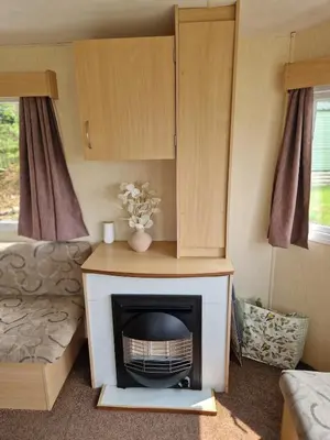 a living room with a fireplace in a caravan at 6 Berth Holiday home near the beach in Morecambe