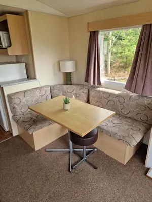 a living room with a couch and a table at 6 Berth Holiday home near the beach in Morecambe