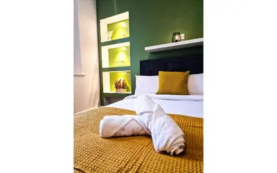 a bedroom with a bed with a towel laying on it at Lodginet Stays - County Luxe - 2BR Flat 1 in Liverpool