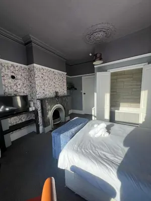 a bedroom with a large bed and a fireplace at No1 Lord street in Blackpool