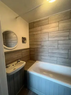 a bathroom with a white tub and a sink at No1 Lord street in Blackpool