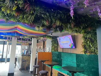 a bar with stools and a colorful ceiling at No1 Lord street in Blackpool