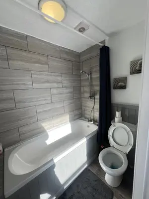 a bathroom with a bath tub and a toilet at No1 Lord street in Blackpool