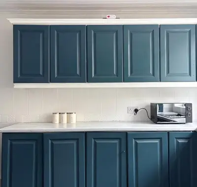 a kitchen with blue cabinets and a microwave at Breck House, 10 Mins to City Centre 5 Min Walk to Anfield Stadium in Liverpool