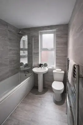 a bathroom with a toilet and a sink and a bath tub at Breck House, 10 Mins to City Centre 5 Min Walk to Anfield Stadium in Liverpool