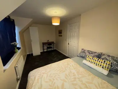 a small bedroom with a bed and a window at EC Prime Home - Wigan, UK in Ince-in-Makerfield