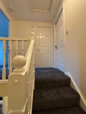 a white stairway with a white door and a stair case at EC Prime Home - Wigan, UK in Ince-in-Makerfield