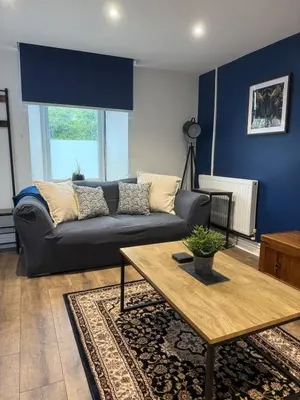 a living room with a couch and a table at Apartment 15 mins to Lake District & BAE Systems in Dalton in Furness