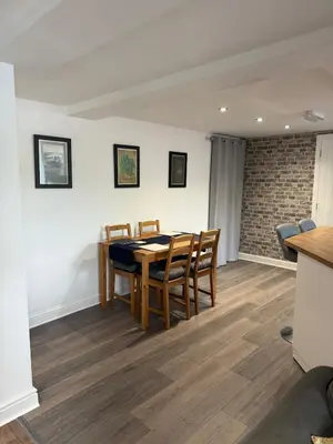 a dining room with a table and chairs at Apartment 15 mins to Lake District & BAE Systems in Dalton in Furness