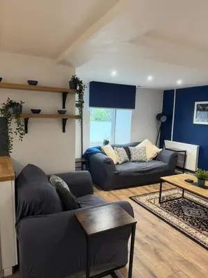 a living room with a couch and a table at Apartment 15 mins to Lake District & BAE Systems in Dalton in Furness
