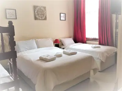 a bedroom with two beds with towels on them at Lyndhurst Hotel in Blackpool